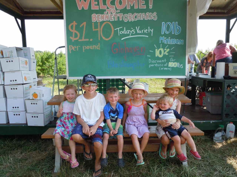 Cheerful family at the pick your own experience at Bennett Orchards